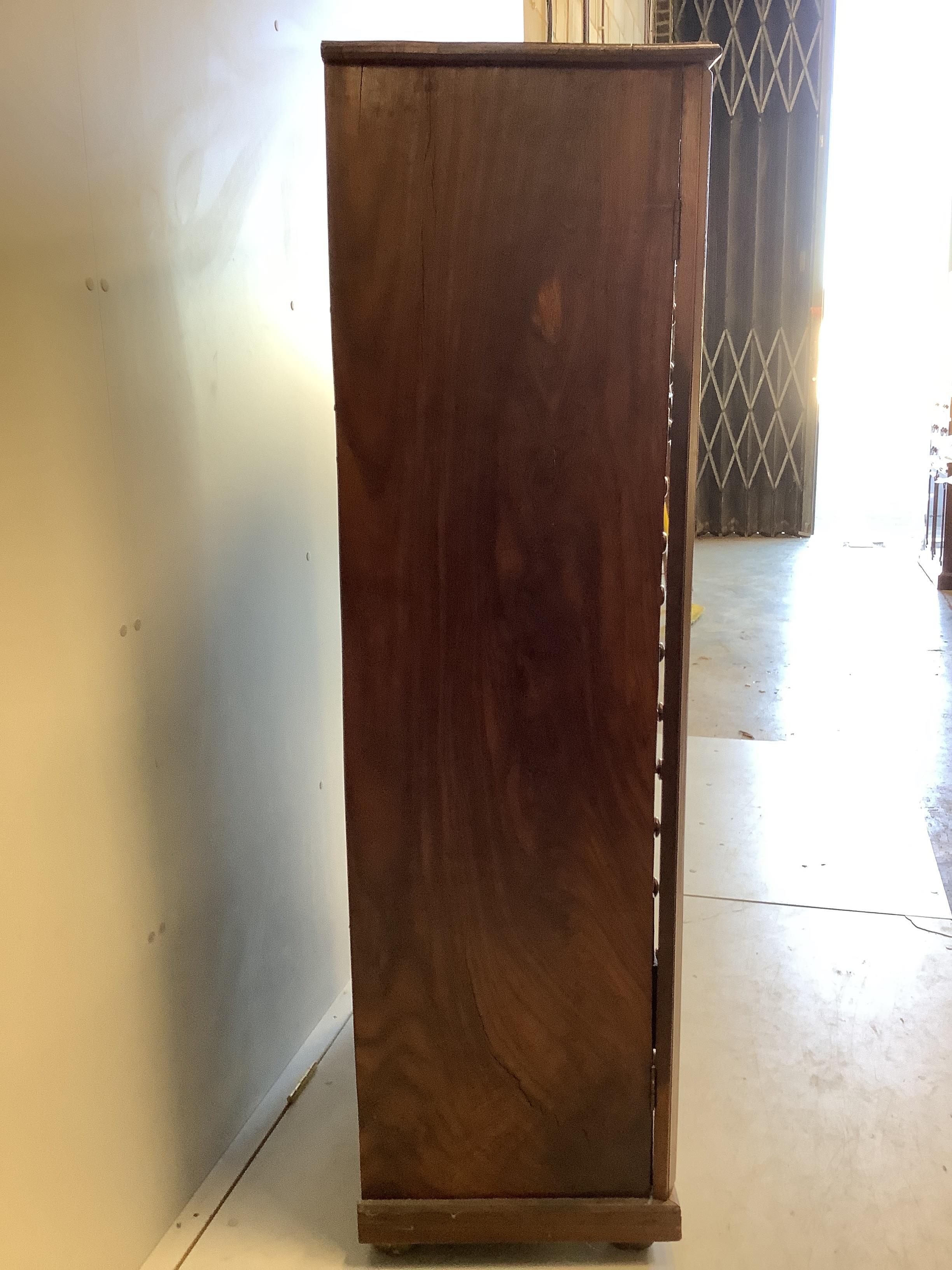 A mid century Sri Lankan mahogany collector's cabinet fitted sixteen graduated drawers, back panel stamped Don Andris, Cabinet Makers, Colombo, width 80cm, depth 44cm, height 156cm